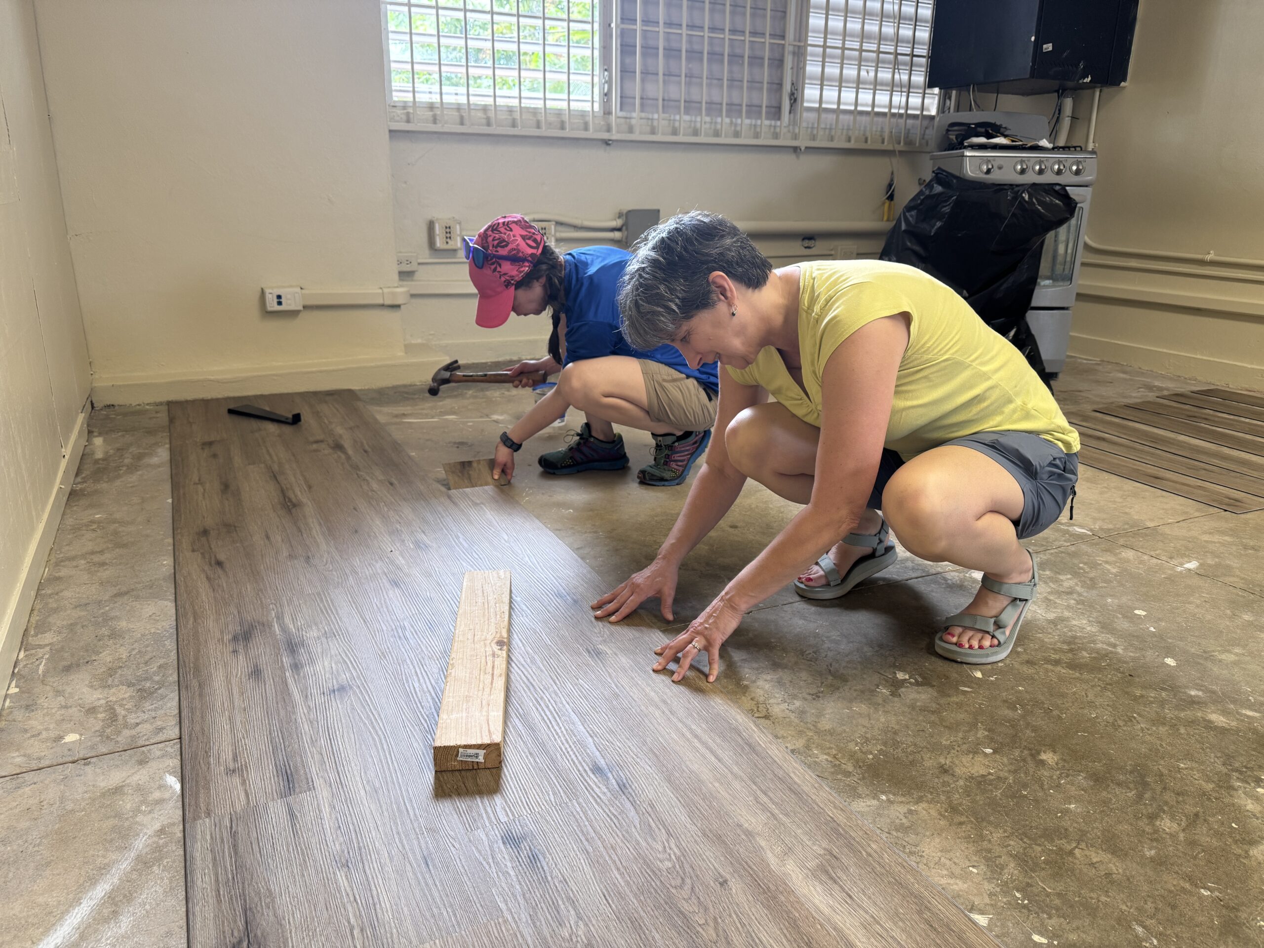 Laying flooring is not for the weak! Val Williamson and Teresa Brooks' knees were feeling it by bedtime that evening.