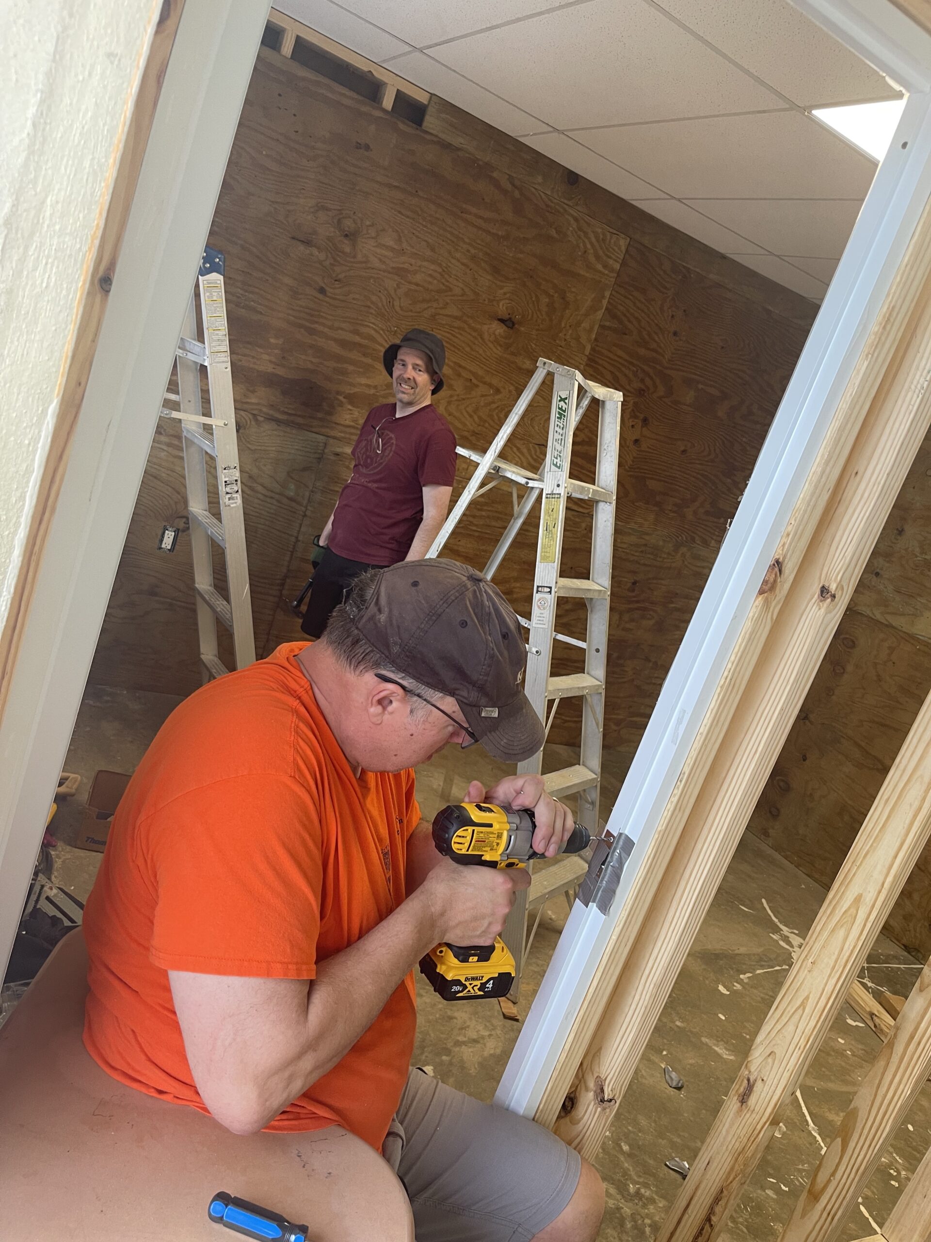 Zach Layman and John Doornink kept smiles on their faces while pushing through to finish the door frames in the new rooms.