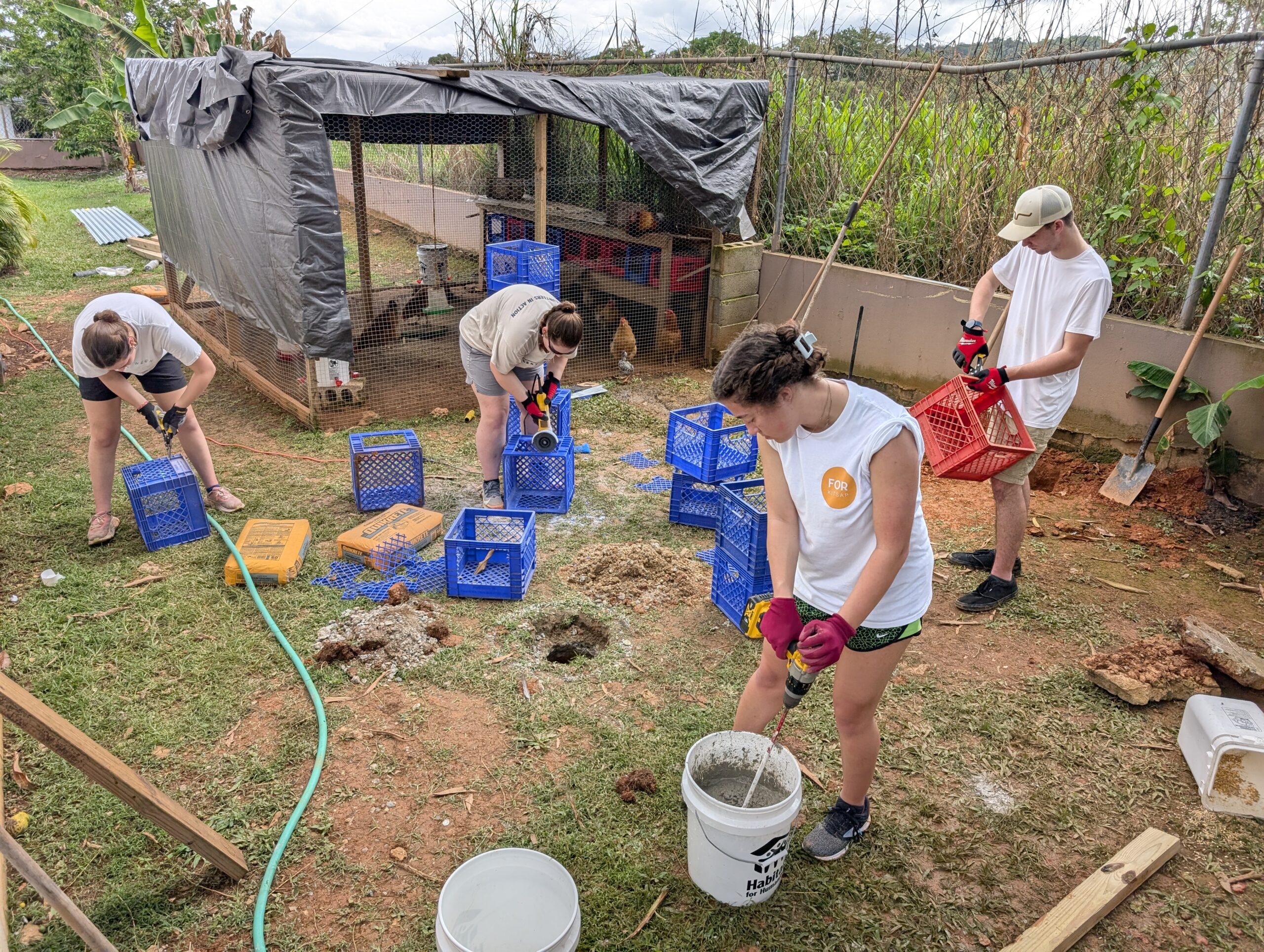 Elijah Dekker, Marlee Jernigan, Leah Morse & Addy Leaf worked hard mixing concrete and cutting out milk crates to be used as chicken beds.