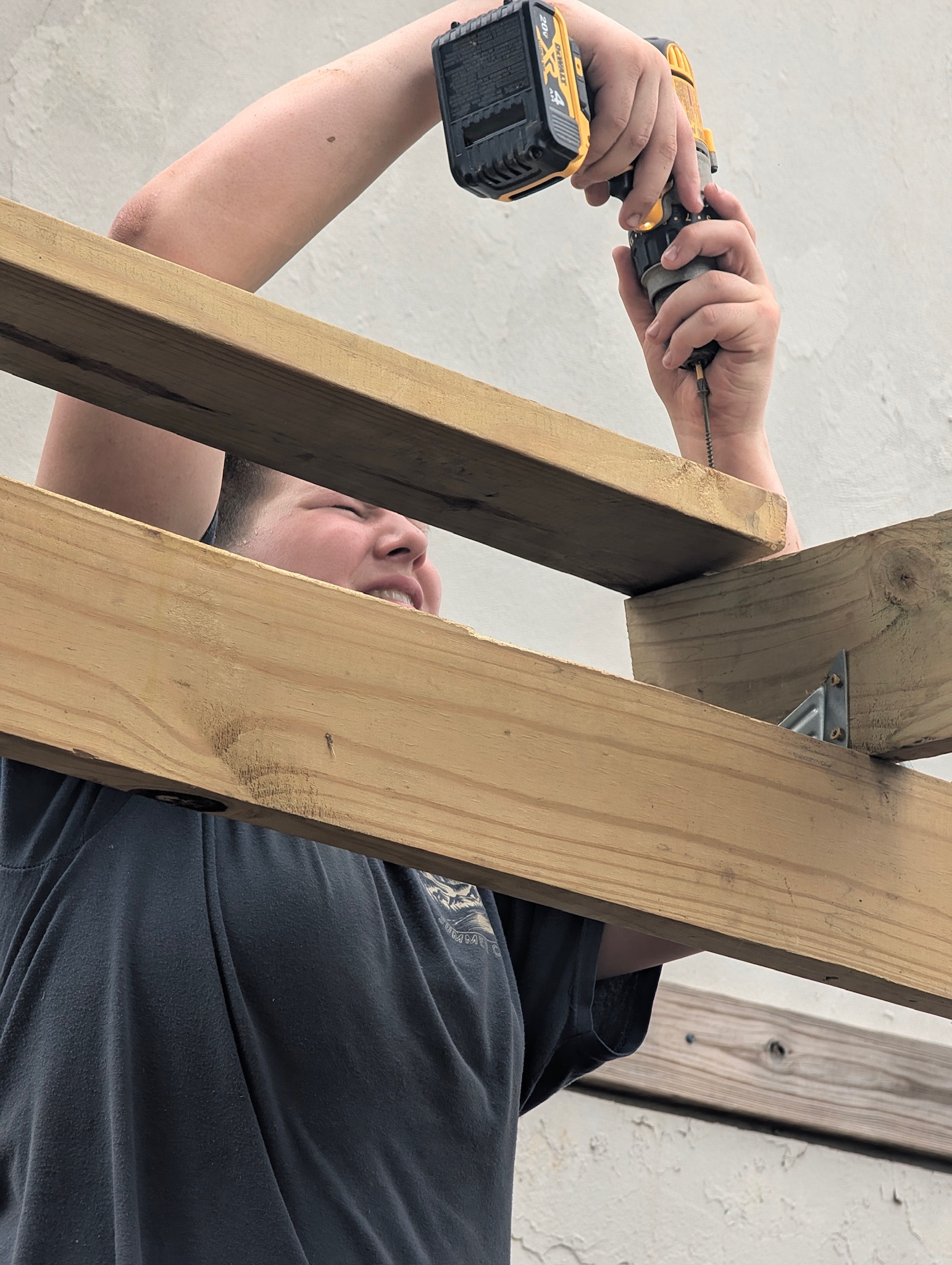 Jack James' height and long arms made him the perfect team member to screw in the high beams.